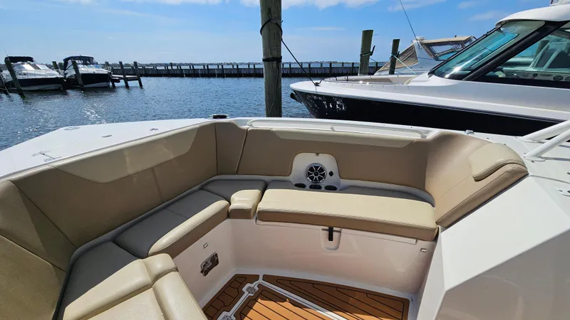 Slide: The Image of 2019 Sailfish 325 DC boat interior with beige seating, docked at marina. - 39