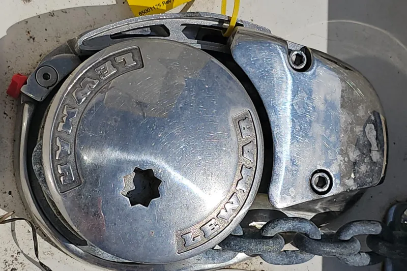 Slide: The Image of Lewmar windlass on 2019 Sailfish 325 DC boat, featuring a metal chain mechanism. - 49