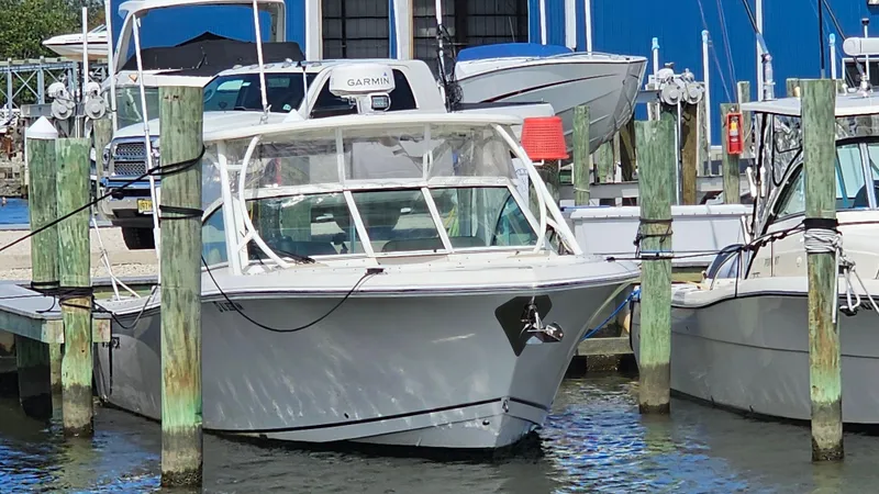 Slide: The Image of 2019 Sailfish 325 DC boat docked at marina, featuring sleek design and modern amenities. - 6