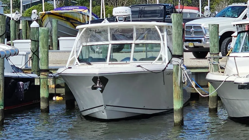 Slide: The Image of 2019 Sailfish 325 DC boat docked at marina, front view. - 8