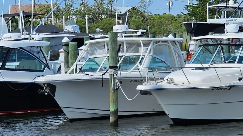 Slide: The Image of 2019 Sailfish 325 DC boat docked among other vessels in a marina. - 9