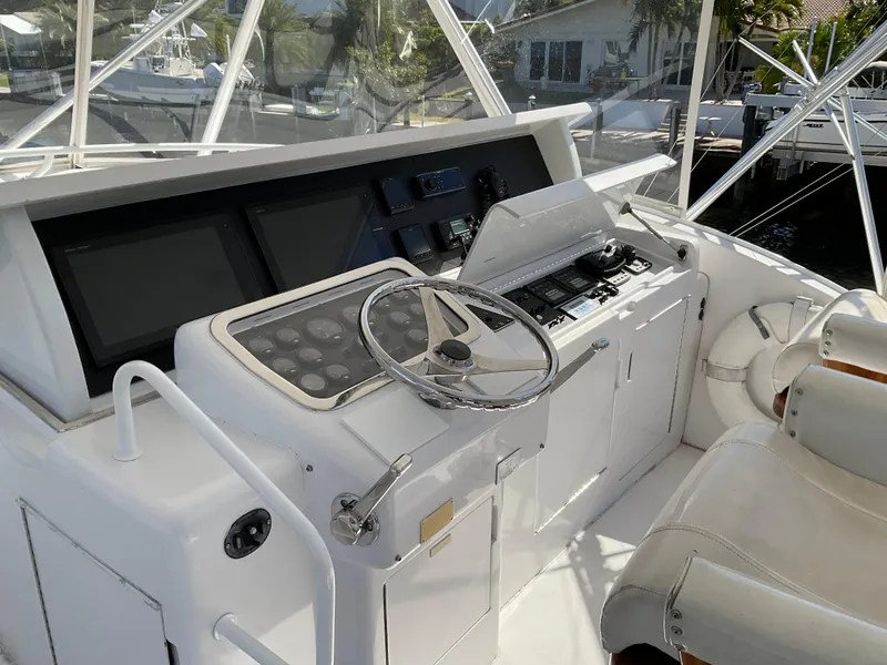 Slide: The Image of 2001 Hatteras 55 Convertible yacht helm with modern controls and navigation equipment. - 1