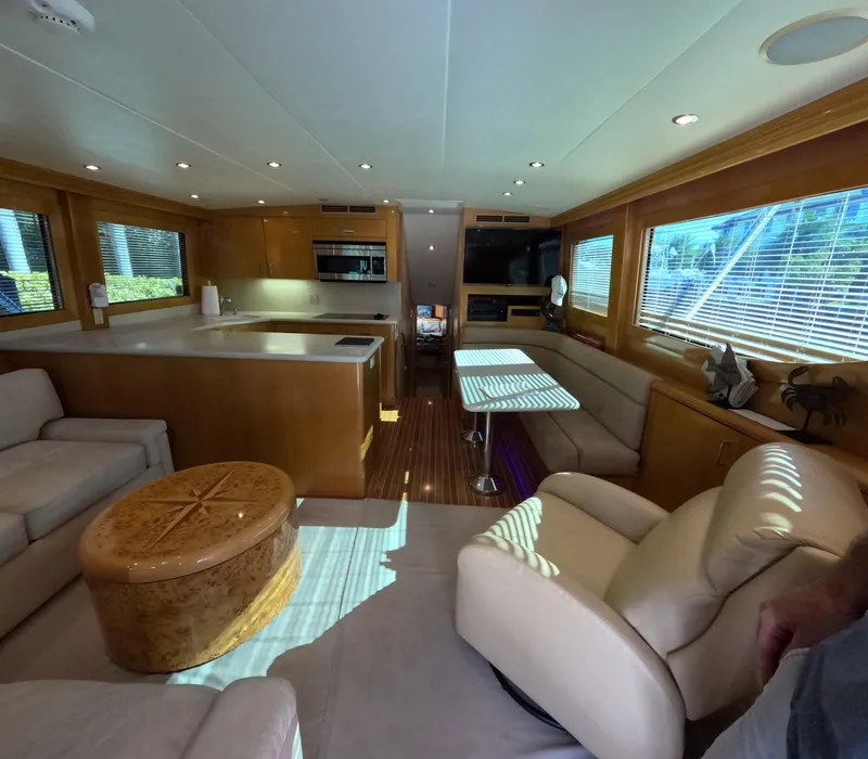 Slide: The Image of Luxurious interior of 2001 Hatteras 55 Convertible yacht with modern furnishings and ample natural light. - 10