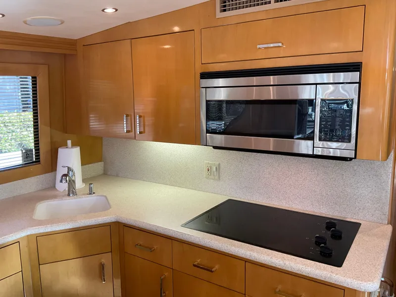 Slide: The Image of Modern kitchen in 2001 Hatteras 55 Convertible yacht with stove, microwave, and sink. - 15