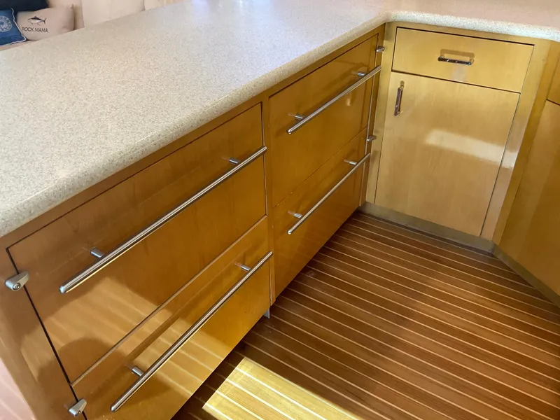 Slide: The Image of Modern kitchen cabinetry on a 2001 Hatteras 55 Convertible yacht, featuring sleek wooden drawers. - 18