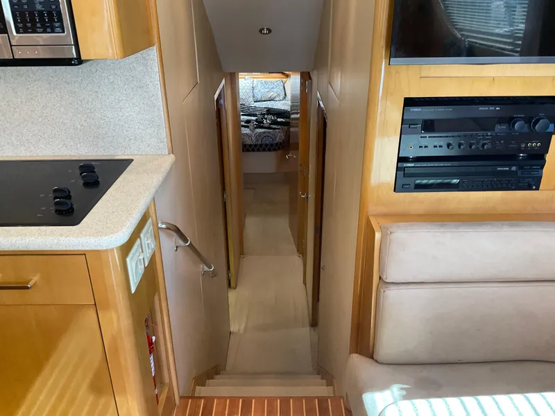 Slide: The Image of Interior view of 2001 Hatteras 55 Convertible yacht, featuring kitchen and hallway to cabin. - 19