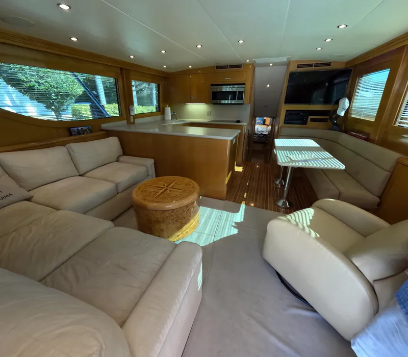 Slide: The Image of Luxurious interior of 2001 Hatteras 55 Convertible yacht with modern furnishings and ample seating. - 2