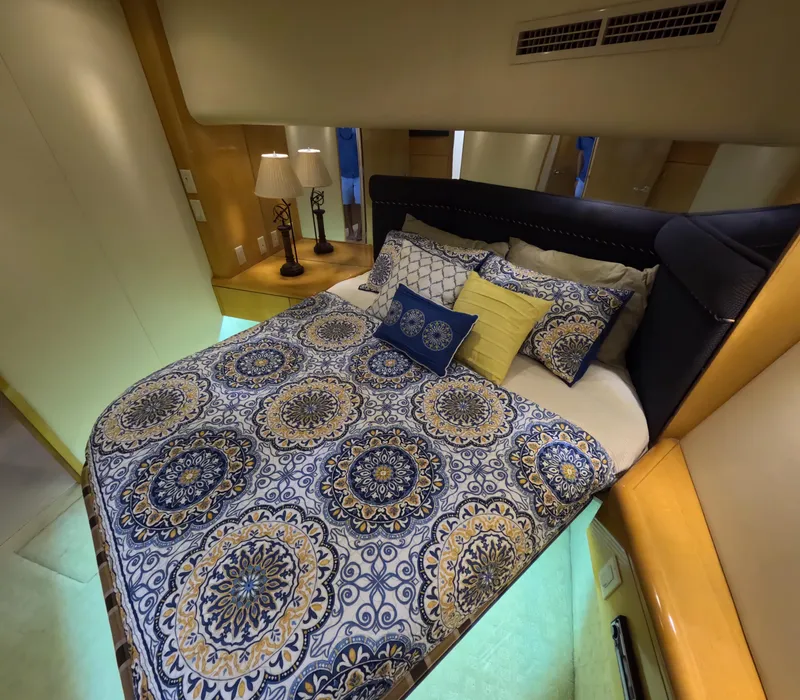Slide: The Image of Luxurious bedroom interior of 2001 Hatteras 55 Convertible yacht with patterned bedding. - 22