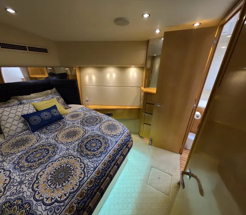 Slide: The Image of Luxurious bedroom interior of 2001 Hatteras 55 Convertible yacht with patterned bedding. - 23