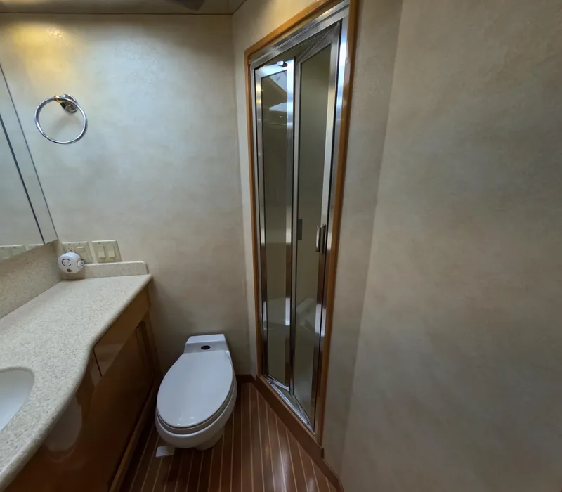 Slide: The Image of Bathroom interior of 2001 Hatteras 55 Convertible yacht with shower and toilet. - 25