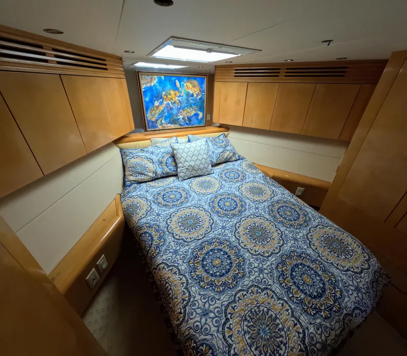 Slide: The Image of Luxurious cabin interior of 2001 Hatteras 55 Convertible yacht with patterned bedding. - 26