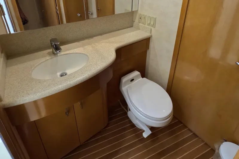 Slide: The Image of Bathroom interior of 2001 Hatteras 55 Convertible yacht with sink and toilet. - 27