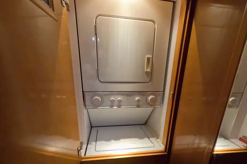 Slide: The Image of Stacked washer and dryer inside 2001 Hatteras 55 Convertible yacht. - 31