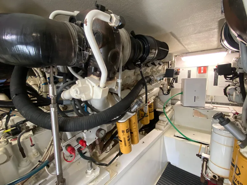 Slide: The Image of Engine room of 2001 Hatteras 55 Convertible yacht, showcasing mechanical components and systems. - 33
