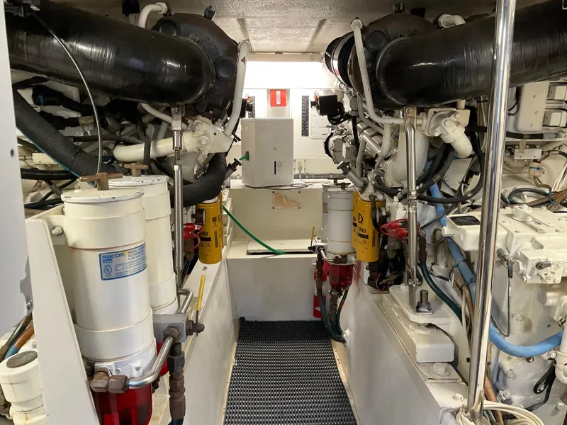 Slide: The Image of Engine room of 2001 Hatteras 55 Convertible yacht, showcasing dual engines and mechanical components. - 38