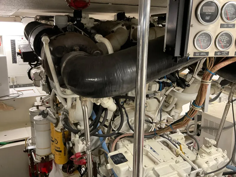 Slide: The Image of Engine room of 2001 Hatteras 55 Convertible yacht, showcasing complex machinery and gauges. - 39