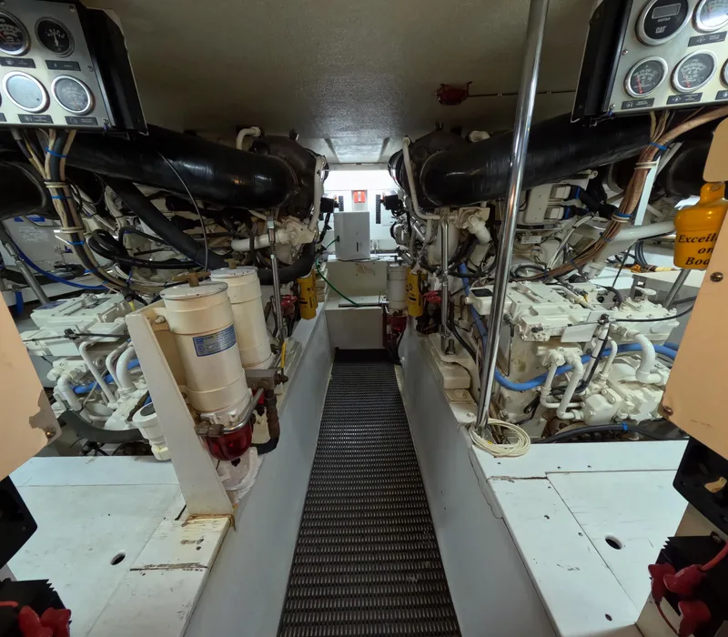 Slide: The Image of Engine room of 2001 Hatteras 55 Convertible yacht, showcasing dual engines and control panels. - 4