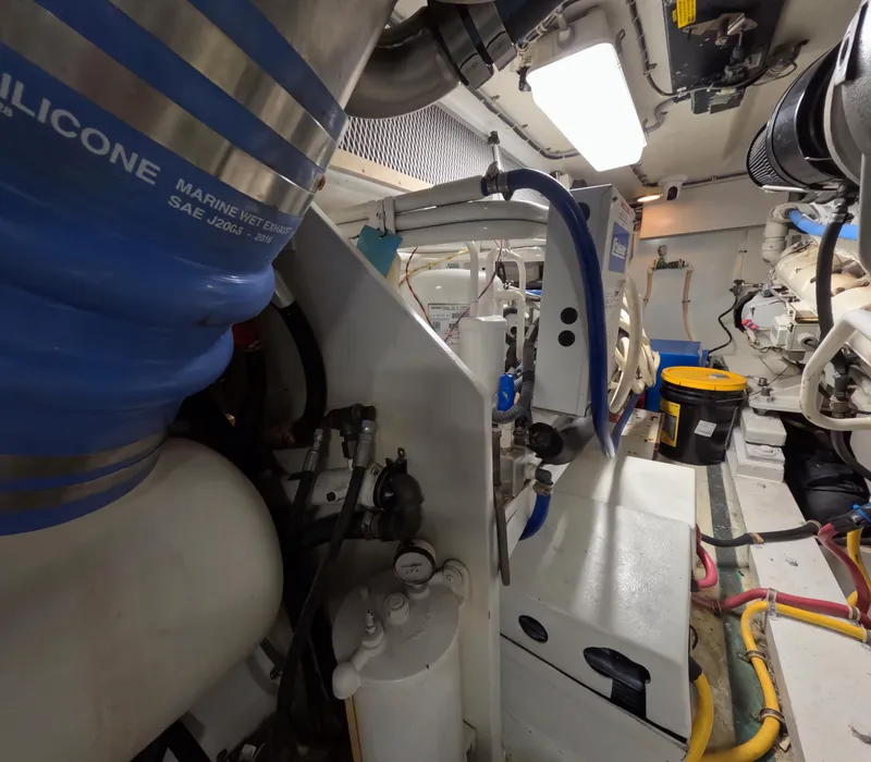 Slide: The Image of Engine room of a 2001 Hatteras 55 Convertible yacht, showcasing mechanical components and equipment. - 40