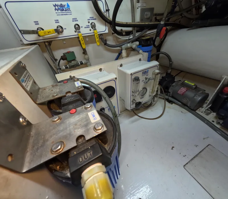 Slide: The Image of Engine room of 2001 Hatteras 55 Convertible yacht, showcasing mechanical components and systems. - 41