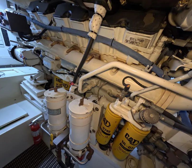 Slide: The Image of Engine room of 2001 Hatteras 55 Convertible yacht with visible CAT filters and components. - 43