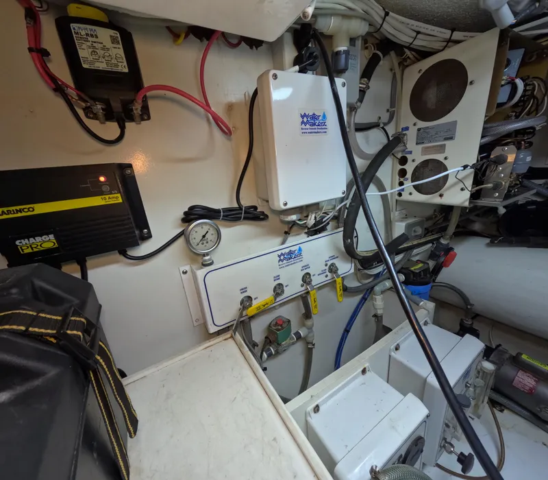 Slide: The Image of Engine room of a 2001 Hatteras 55 Convertible yacht, showcasing electrical components and wiring. - 45