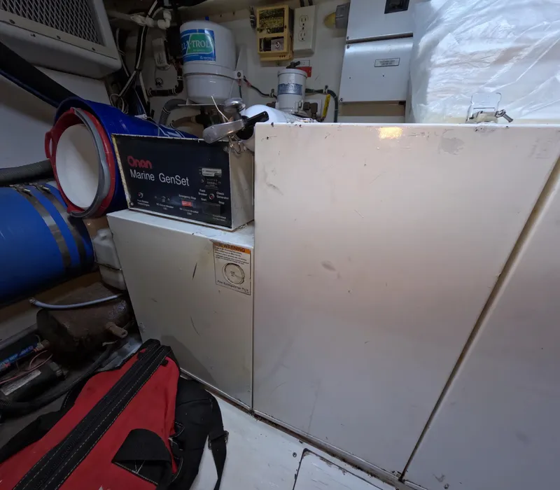 Slide: The Image of Engine room of 2001 Hatteras 55 Convertible with Onan Marine GenSet. - 49