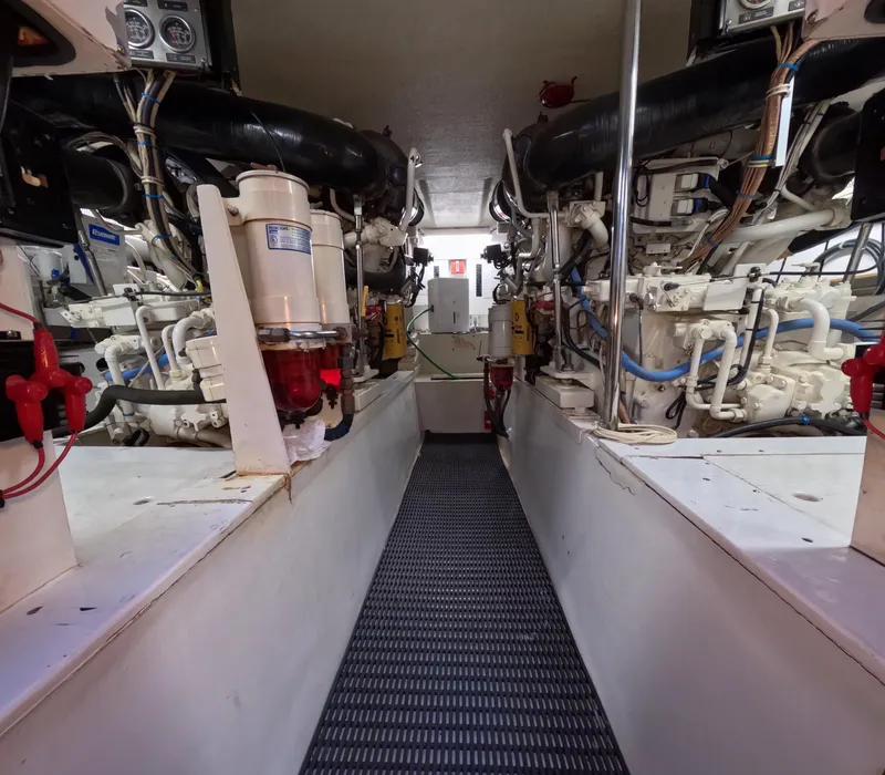 Slide: The Image of Engine room of 2001 Hatteras 55 Convertible yacht, showcasing dual engines and mechanical systems. - 50