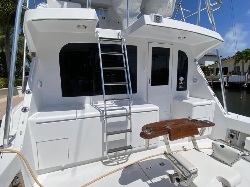 Slide: The Image of 2001 Hatteras 55 Convertible yacht with ladder and fishing chair on deck. - 52