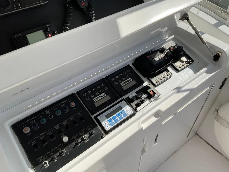 Slide: The Image of Control panel of a 2001 Hatteras 55 Convertible yacht, featuring navigation and communication equipment. - 6