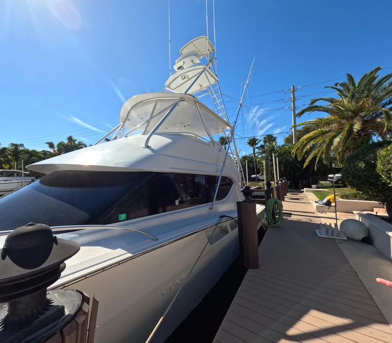 Slide: The Image of 2001 Hatteras 55 Convertible yacht docked under clear blue sky. - 61