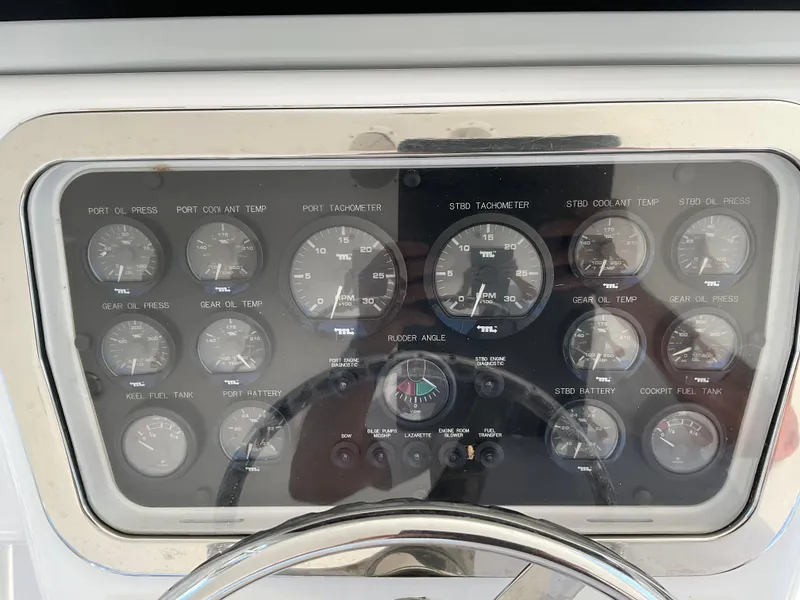 Slide: The Image of Instrument panel of a 2001 Hatteras 55 Convertible yacht, featuring various gauges and controls. - 67