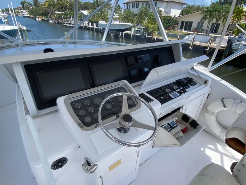 Slide: The Image of Helm of 2001 Hatteras 55 Convertible yacht with modern navigation equipment. - 70