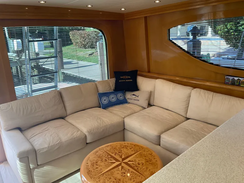 Slide: The Image of Luxurious interior of 2001 Hatteras 55 Convertible yacht with beige sectional sofa. - 8