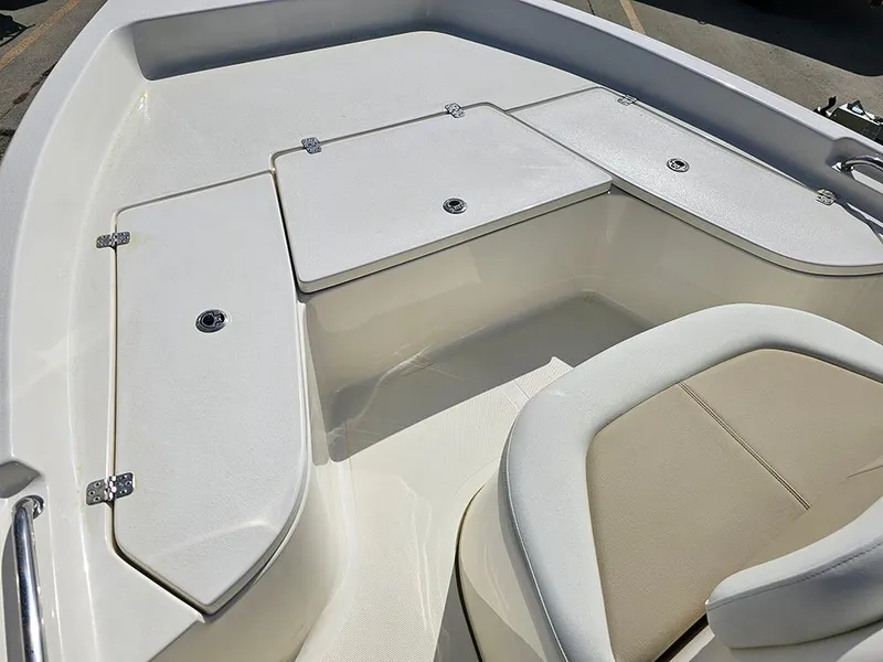 Slide: The Image of 2025 Bulls Bay 2000 boat interior with storage compartments and seating. - 12