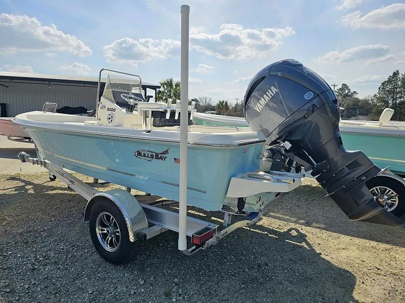 Slide: The Image of 2025 Bulls Bay 2000 boat with Yamaha engine on trailer, parked outdoors. - 4