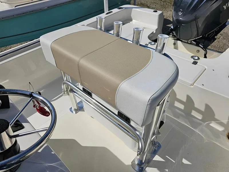 Slide: The Image of Bulls Bay 2000 boat interior, featuring a cushioned seat and steering wheel, 2025 model. - 9