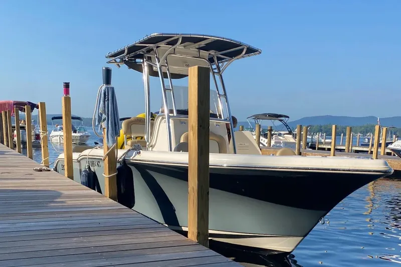 Slide: The Image of 2019 Key West 239 FS boat docked at a marina on a sunny day. - 2