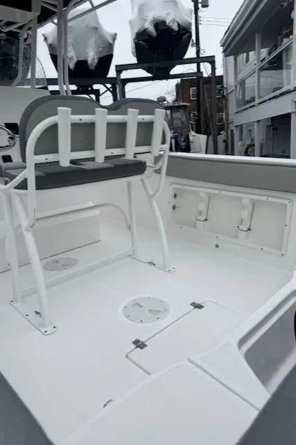Slide: The Image of 2022 Aquasport 2100 Center Console boat interior with seating and storage compartments. - 11