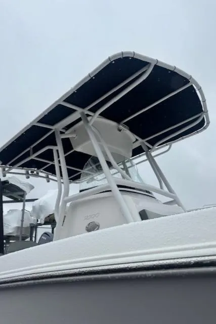 Slide: The Image of 2022 Aquasport 2100 Center Console boat with T-top, side view. - 16