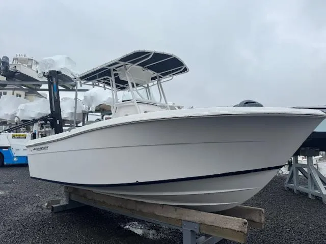 Slide: The Image of 2022 Aquasport 2100 Center Console boat on display in a marina setting. - 17