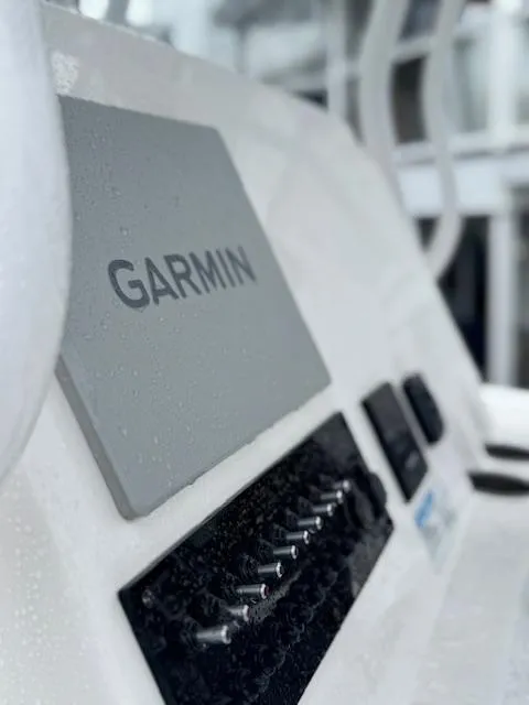 Slide: The Image of Close-up of Garmin equipment on 2022 Aquasport 2100 Center Console boat. - 2