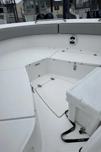 Slide: The Image of 2022 Aquasport 2100 Center Console boat interior with seating and storage compartments. - 5