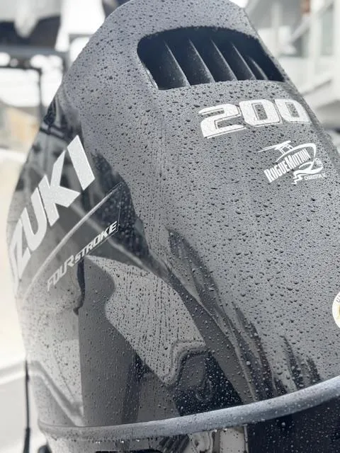 Slide: The Image of Close-up of Suzuki 200 outboard motor on 2022 Aquasport 2100 Center Console boat. - 6
