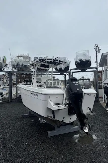 Slide: The Image of 2022 Aquasport 2100 Center Console boat on display in a marina setting. - 7