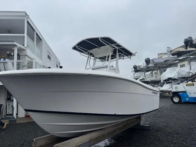 Slide: The Image of 2022 Aquasport 2100 Center Console boat on display in a marina setting. - 8
