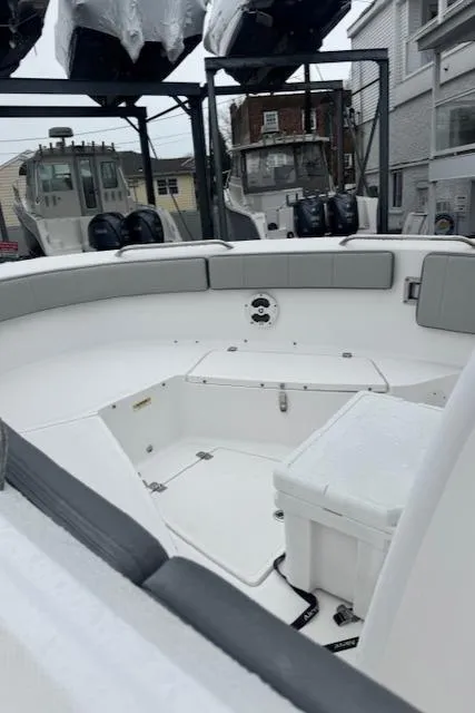 Slide: The Image of 2022 Aquasport 2100 Center Console boat interior with seating and storage compartments. - 9