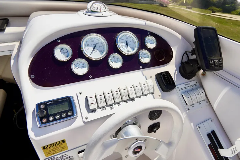 Slide: The Image of Dashboard of a 1999 Donzi 26 ZX boat with gauges and controls. - 12