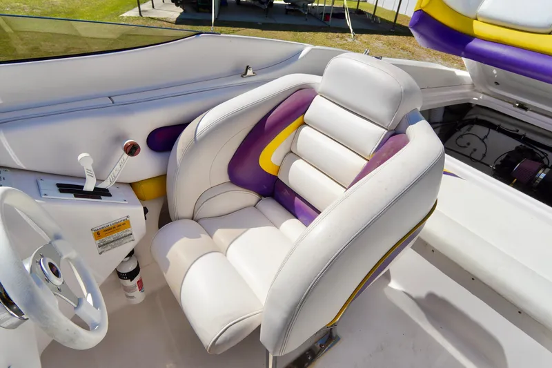 Slide: The Image of 1999 Donzi 26 ZX boat interior with white and purple seating. - 14
