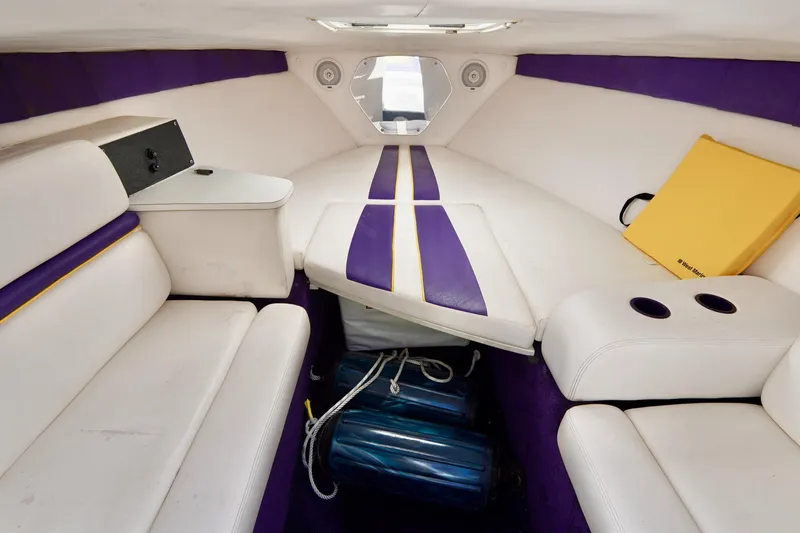 Slide: The Image of Interior of a 1999 Donzi 26 ZX boat with white and purple seating. - 15