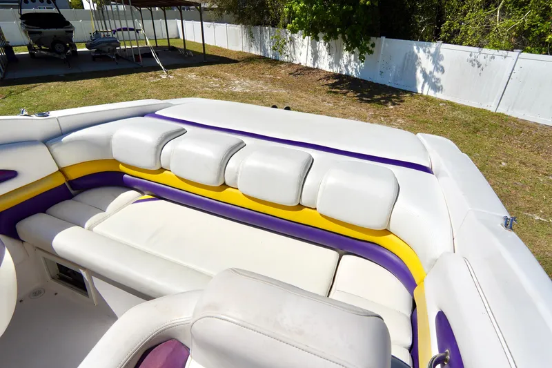 Slide: The Image of 1999 Donzi 26 ZX boat interior with white, yellow, and purple seating. - 20